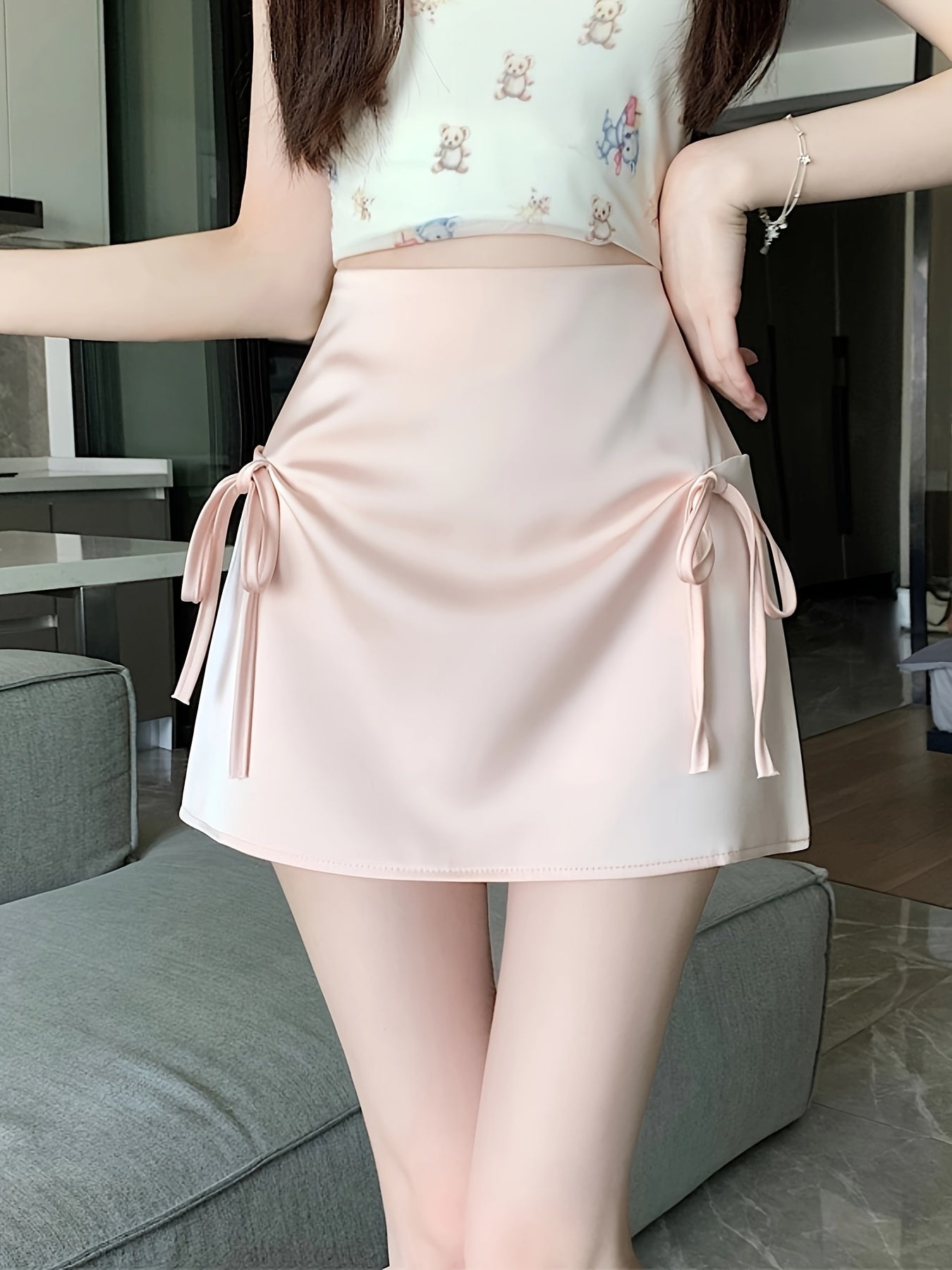 Pink Satin Half-Length Skirt for Women, Designed to Hide Imperfections, Featuring a Bow, High Waist, Slimming A-Line Shape, And Body-Hugging Fit.